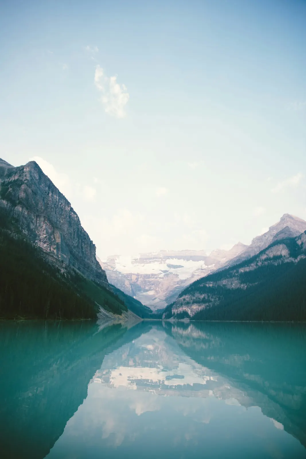 Mountains and a glacier reflected in a still turquoise lake